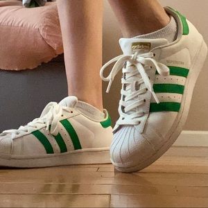 Adidas superstars with green stripes